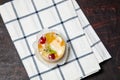 Cake with jelly, kiwi, cherries and mango on table