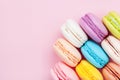 Cake macaron or macaroon on pink pastel background top view. Flat lay composition.