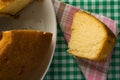 Cake made of corn. Sweet food of Festa Junina, a typical brazilian party, holiday event in June. Slice on plaid pattern. Royalty Free Stock Photo