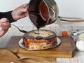 Cake making process. Women is hands are icing the homemade cake Enchantress