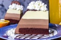 Cake mousse three chocolates , slice of cake on plate.