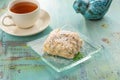 Cake Napoleon puff pastry dessert with cream and cup of black tea on blue wooden table Royalty Free Stock Photo