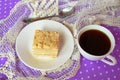 Cake Napoleon on a white plate, a Cup of coffee