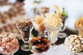 Cake, nuts, fruits on candy bar on wedding reception