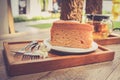 Cake on plate with fork and flower on wood table vintage tone. Royalty Free Stock Photo