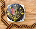 Cake on a plate and St. George ribbons on a wooden background in honor of May 9