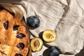 Cake with plum and cinnamon, traditional american plum torte, pie on beige linen background Royalty Free Stock Photo