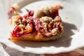 Cake with plums and crumble on plate, sunny day Royalty Free Stock Photo