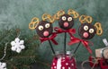 Cake pops Santa reindeers made from cookies in chocolate and crackers on green, Idea Christmas treats for childrens Royalty Free Stock Photo