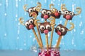 Cake pops Santa reindeers from marshmallows, sweet straw and chocolate on blue background, Idea Christmas treats for Royalty Free Stock Photo