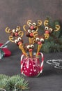 Cake pops Santa reindeers from marshmallows, sweet straw and chocolate on brown background, Idea Christmas treats for Royalty Free Stock Photo