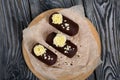 Cake potato. Decorated with butter cream. Against the background of black pine boards. Shot from above, close-up Royalty Free Stock Photo