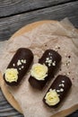 Cake potato. Decorated with butter cream. Against the background of black pine boards. Shot from above, close-up Royalty Free Stock Photo