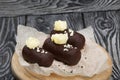 Cake potato. Decorated with butter cream. Against the background of black pine boards. Shot close-up Royalty Free Stock Photo