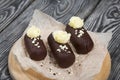 Cake potato. Decorated with butter cream. Against the background of black pine boards. Shot close-up Royalty Free Stock Photo