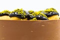 Cake with profiterol and chocolate pistachio