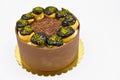 Cake with profiterol and chocolate pistachio