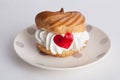 Cake profiteroles with cream and marmalade heart