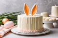 Cake with rabbit ears for Easter, birthday, holiday. Easter cake, kulich surrounded by painted eggs with spring flower Royalty Free Stock Photo