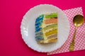 Cake with a rainbow filling, on a crimson background