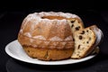 Cake, raisins in plate, black background