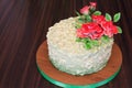 Cake with red roses on a wooden background Royalty Free Stock Photo