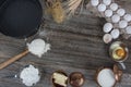 Cake in rural kitchen - dough recipe ingredients eggs, flour, milk, butter, sugar and rolling pin on vintage wooden table from Royalty Free Stock Photo