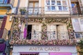 Cake shop and decorated balcony in residential building at city