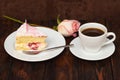 Cake slice and coffee cup with rose on wooden background Royalty Free Stock Photo