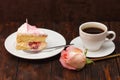 Cake slice and coffee cup with rose on wooden background Royalty Free Stock Photo