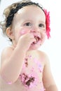 Cake smash shoot: Messy baby girl eating birthday cake! Royalty Free Stock Photo