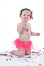 Cake smash shoot: Messy baby girl eating birthday cake! Royalty Free Stock Photo