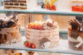 cake with strawberries, yummy assortment baked pastry in bakery. Various Different Types Of Sweet Cakes In Pastry Shop