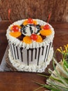 Cake with topper fresh orange, chocolate and cerry