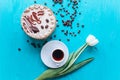 Cake, tulips and coffee on blue background Royalty Free Stock Photo