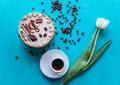 Cake, tulips and coffee on blue background Royalty Free Stock Photo