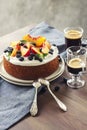 Cake with whipped cream and fresh fruits - peaches and blueberries and coffee, round coffee cake
