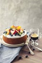 Cake with whipped cream and fresh fruits - peaches and blueberries and coffee, round coffee cake, summer celebration birthday cake