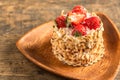 Cake on wooden bowl.