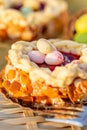 Cake on a wooden table and bronze paper. Easter Sponge cake nest. Nuts and oval sweet sweets in the form of eggs. Royalty Free Stock Photo