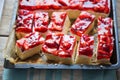 Cake with yoghurt and lemon layers with strawberries and jelly