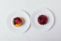 Cakes with berries on white table, top view Royalty Free Stock Photo