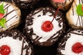 Cakes with chocolate, cherries and cream, top view