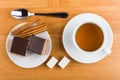 Cakes with chocolate in plate, cinnamon, sugar, tea and teaspoon Royalty Free Stock Photo