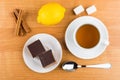 Cakes with chocolate in saucer, cinnamon sticks, lemon, sugar, t Royalty Free Stock Photo