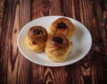 Cakes of cottage cheese with fruit jam, on an old wooden background