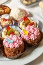 Cakes with cream, grated chocolate, sugar powder