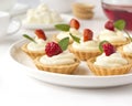 Cakes, cupcakes with fresh fruits (strawberries), whipped cream and mints Royalty Free Stock Photo