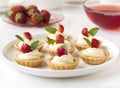 Cakes, cupcakes with fresh fruits (strawberries), whipped cream and mints Royalty Free Stock Photo