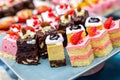 Cakes with different decorations on the plate Royalty Free Stock Photo